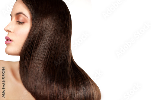 Beauty model showing perfect skin and long healthy brown hair