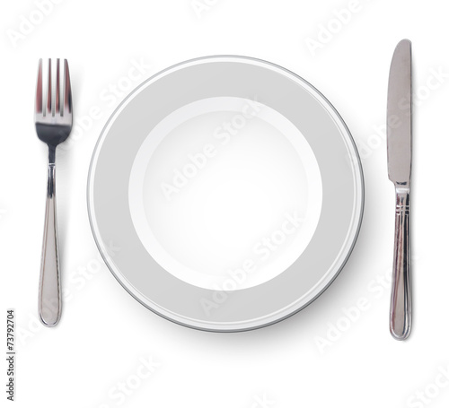 Empty plate with knife and fork on a white
