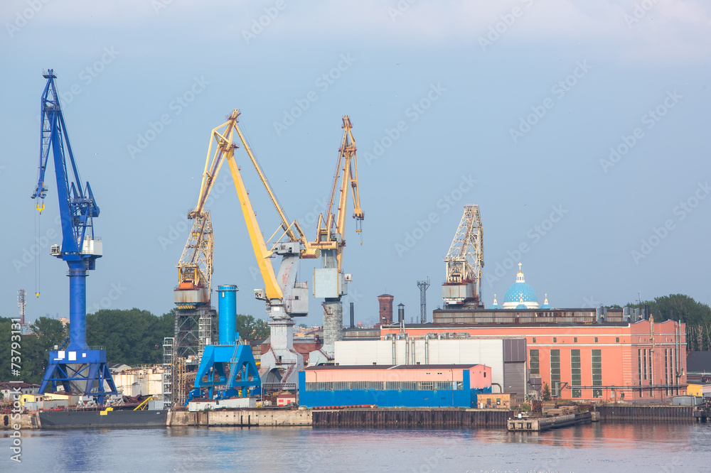 port cranes with old  warehose. Port of St.Petersburg, Russia