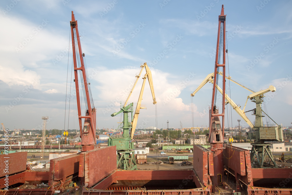 Two port cranes with cargo train. Port of St.Petersburg, Russia