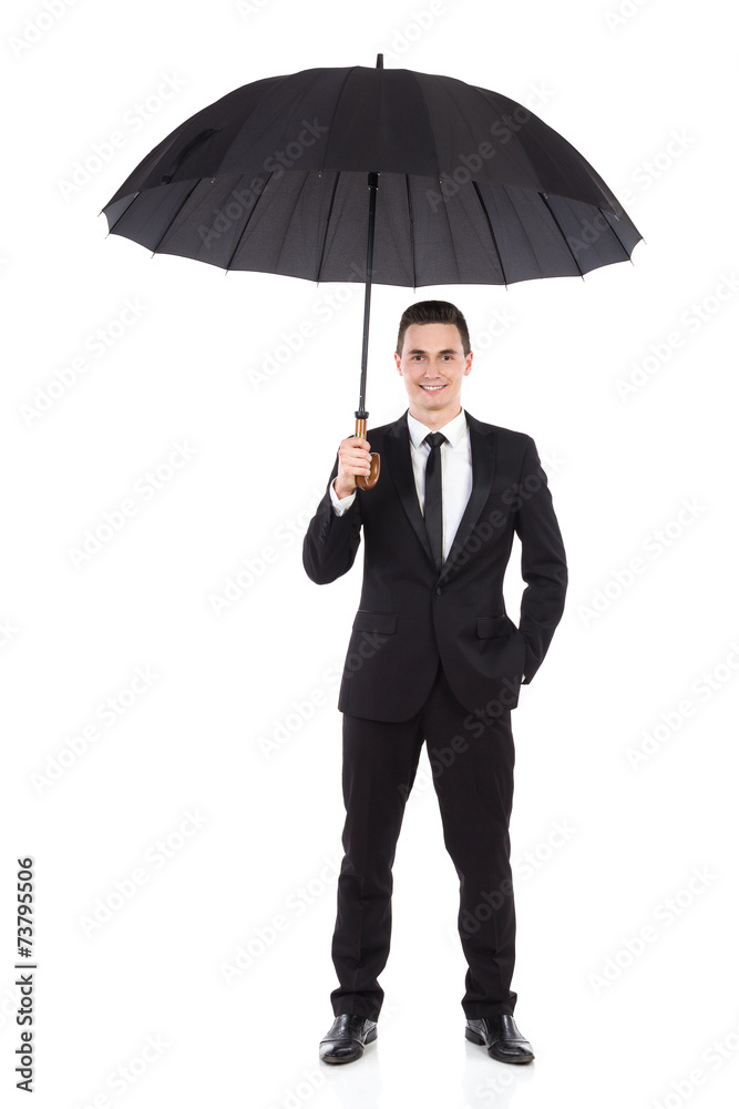 Smiling businessman standing with open umbrella Smiling businessman standing with open umbrella
