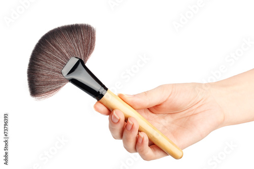 Makeup brush in hand