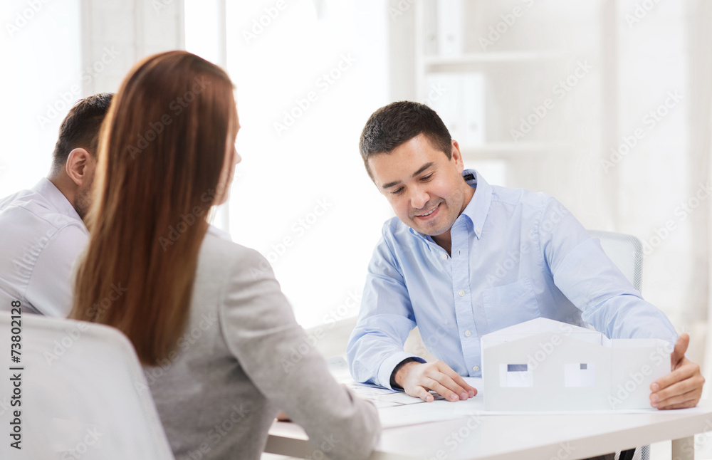 couple looking at model of their house at office couple looking at model of their house at office