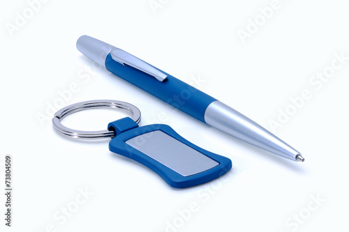 Silver-blue metal pen and keychain isolated on white