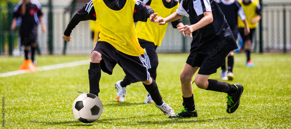 Football match for children. Boys playing football Football match for children. Boys playing football