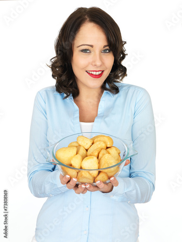 Young Woman Holding Bowl Of Roast Potatoes photo
