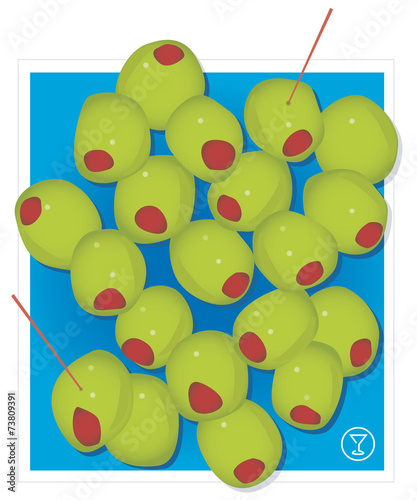 Stylish green cocktail olives with red pimentos against blue bac