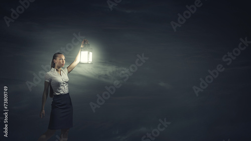 Businesswoman with lantern