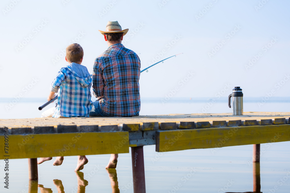 boy and his father fishing togethe boy and his father fishing togethe