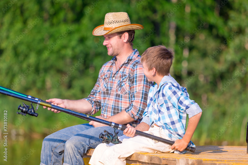 boy and his father fishing togethe boy and his father fishing togethe