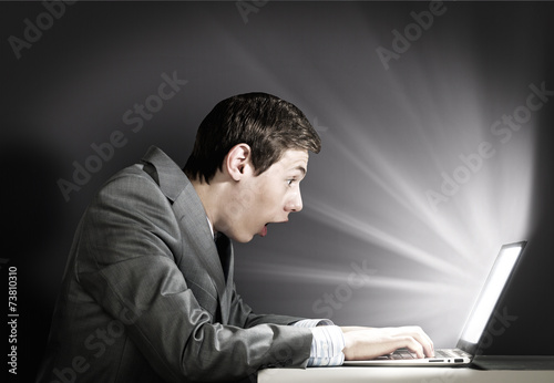 Emotional man using laptop