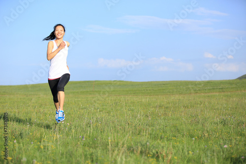 young asian woman on green grassland 