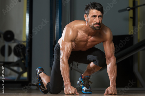 Strong Muscular Men Kneeling On The Floor