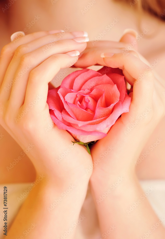 Closeup image of pink french manicure with rose