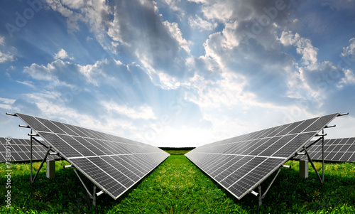 Solar energy panels against sunset sky