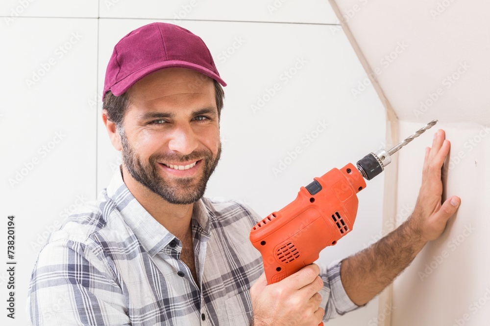 Construction worker drilling hole in wall Construction worker drilling hole in wall