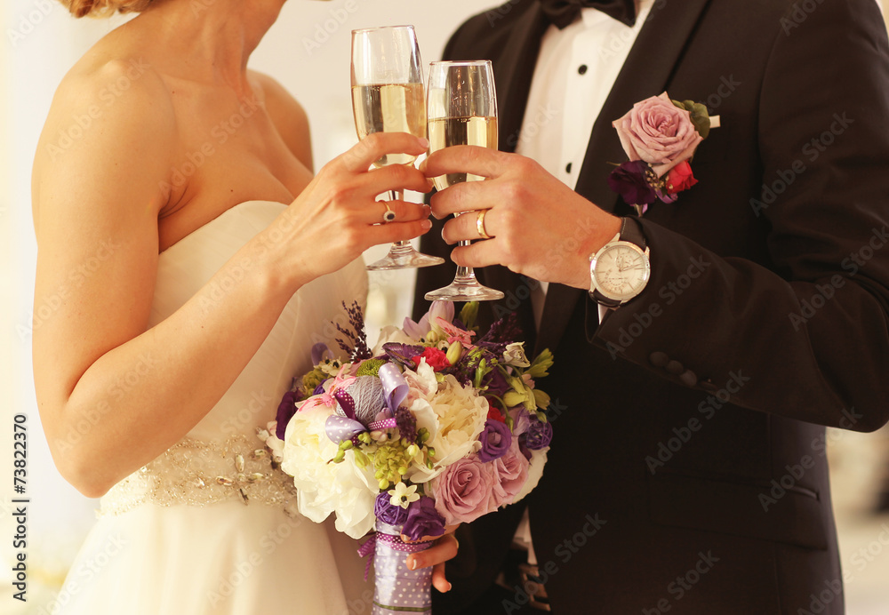 Bride and groom holding glasses of champagne Bride and groom holding glasses of champagne