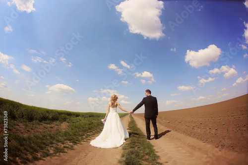 Bride and groom having fun on the fields