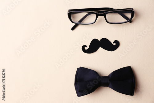 Glasses, mustache and bow tie forming man face