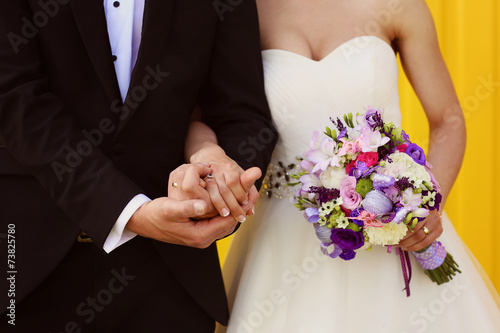 Bride and groom on a yellow background