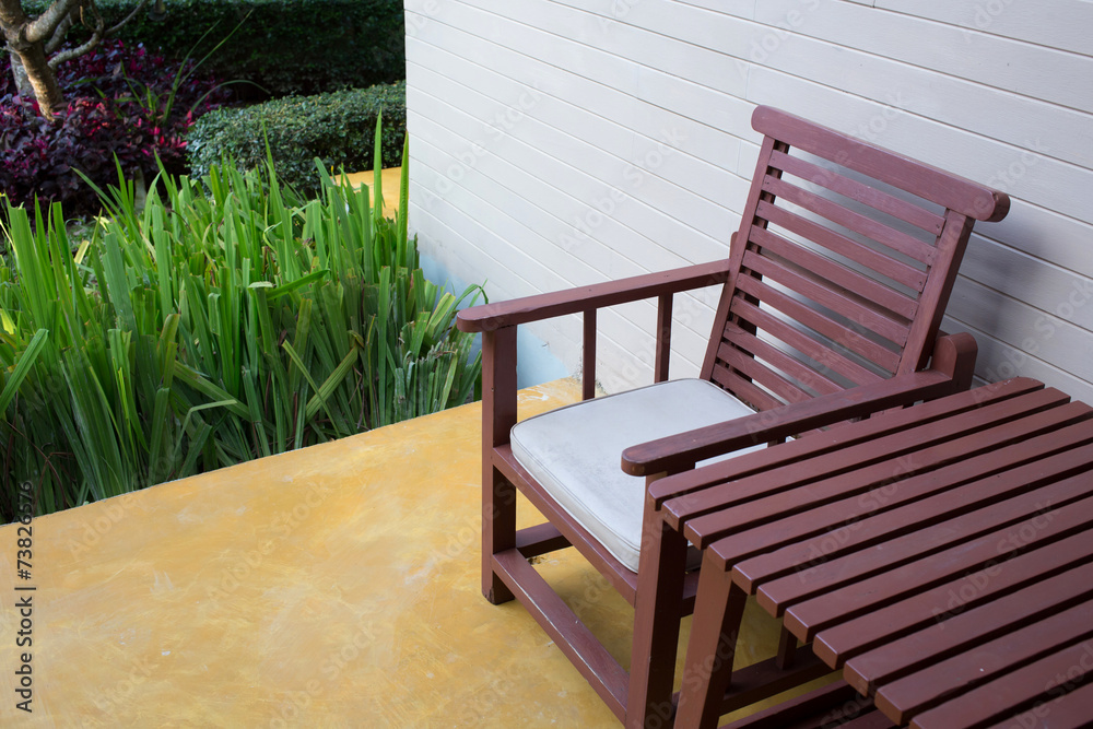 wooden chair on yellow cement floor with mortar wall background wooden chair on yellow cement floor with mortar wall background