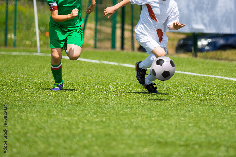 Football match for children. Boys playing football Football match for children. Boys playing football