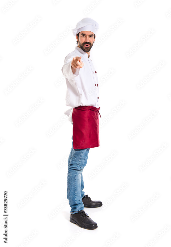 Chef pointing to the front over white background Chef pointing to the front over white background