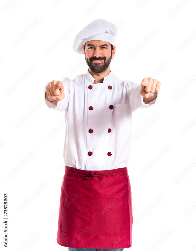 Chef pointing to the front over white background Chef pointing to the front over white background