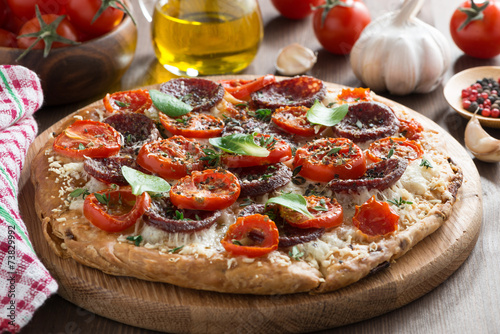 Italian food - pizza with salami and tomatoes
