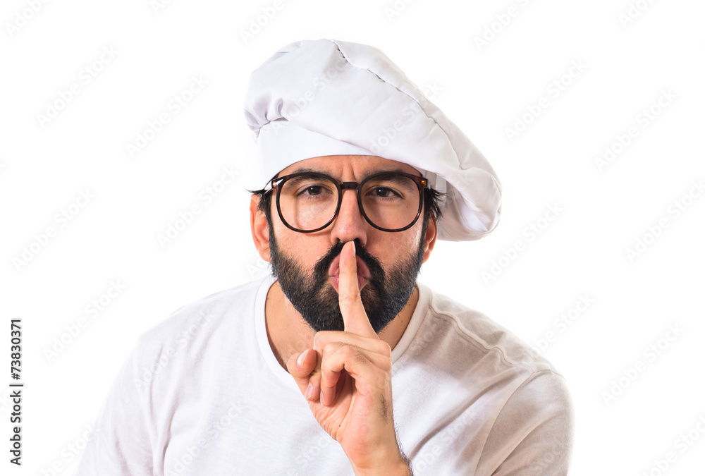 Chef making silence gesture over white background Chef making silence gesture over white background