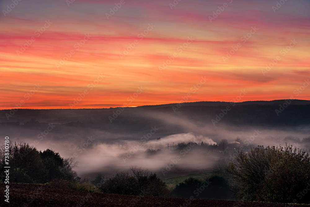 Fototapeta premium Sunset over a valley during autumn