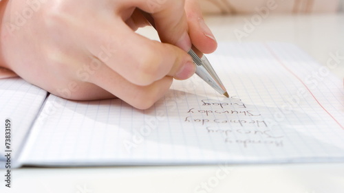 Child writing homework closeup 