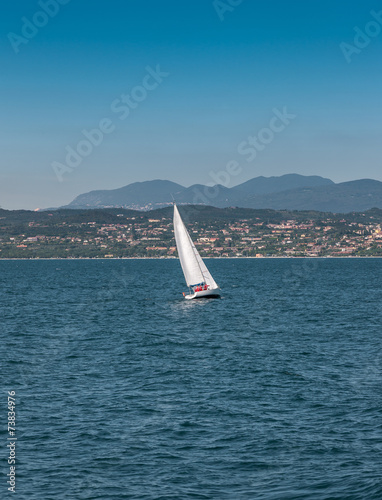 Sail boat on a lake with mountains as background © master1305