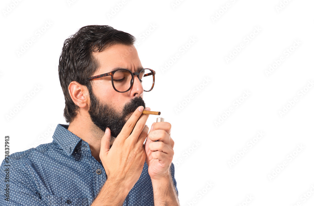 Young hipster man smoking over white background Young hipster man smoking over white background
