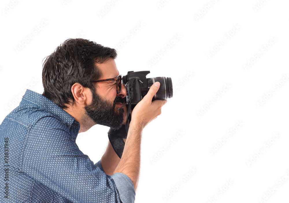 Young hipster man photographing over white background Young hipster man photographing over white background