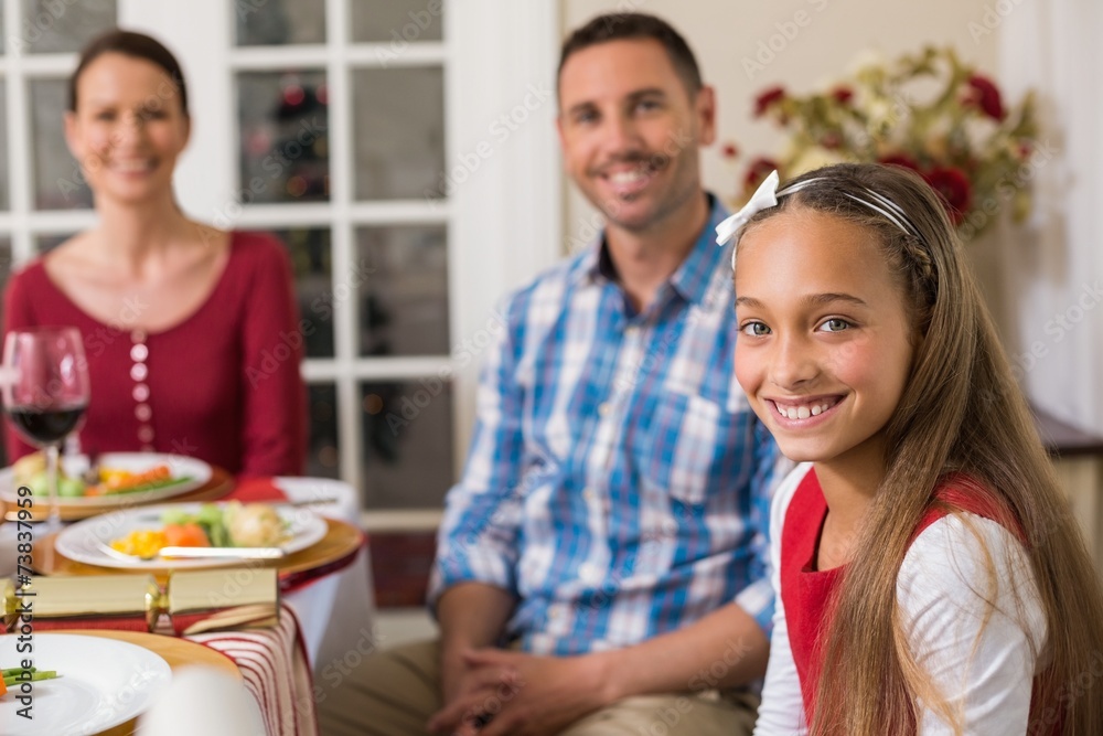 Portrait of cute girl with her parents behind Portrait of cute girl with her parents behind