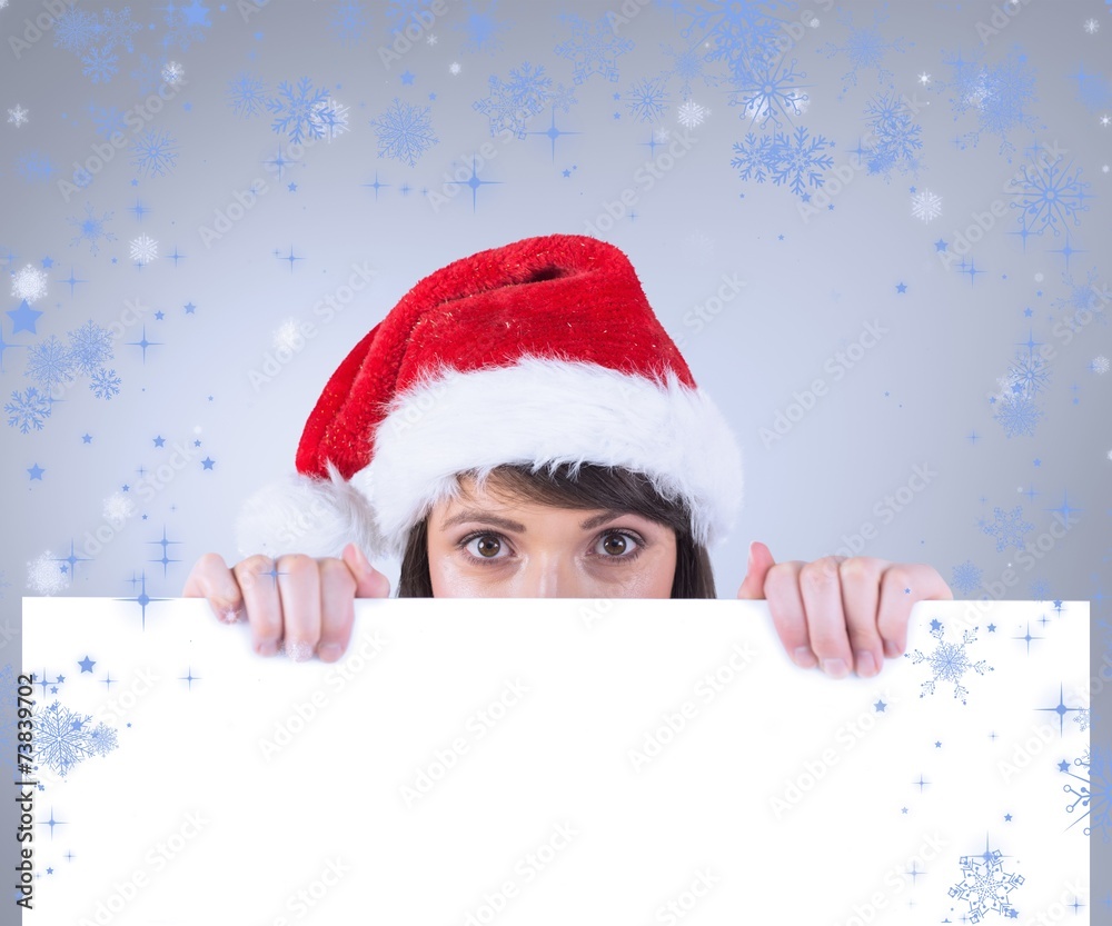 Composite image of festive brunette holding a poster Composite image of festive brunette holding a poster