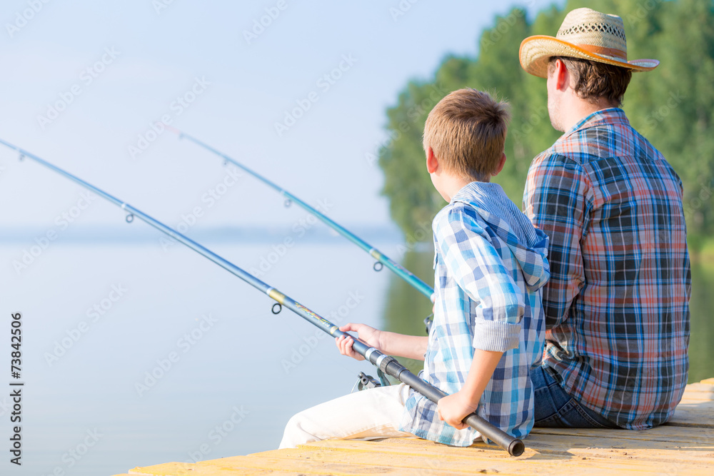 boy and his father fishing togethe boy and his father fishing togethe