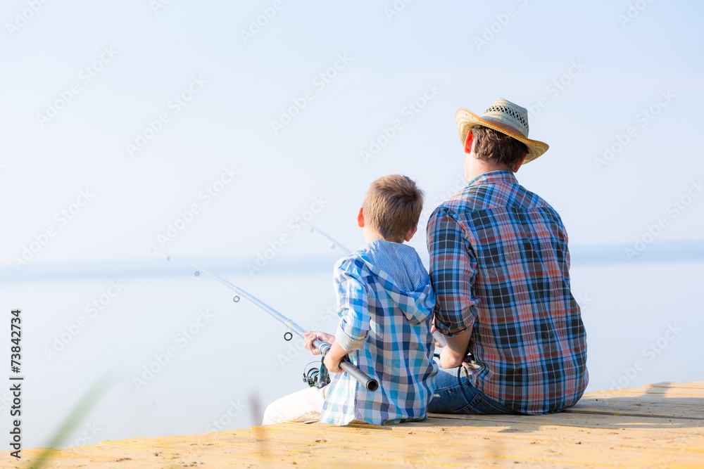 boy and his father fishing togethe boy and his father fishing togethe