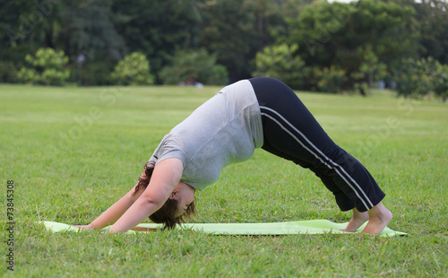 obese women yoga on grass