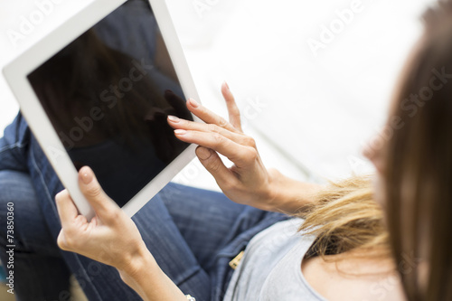 Young woman with tablet at ...