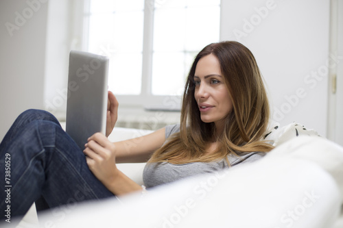 Young woman with tablet at home