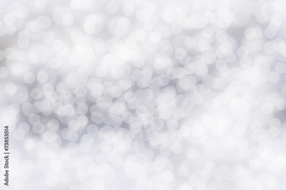 Silver festive glitter background with defocused lights Silver festive glitter background with defocused lights