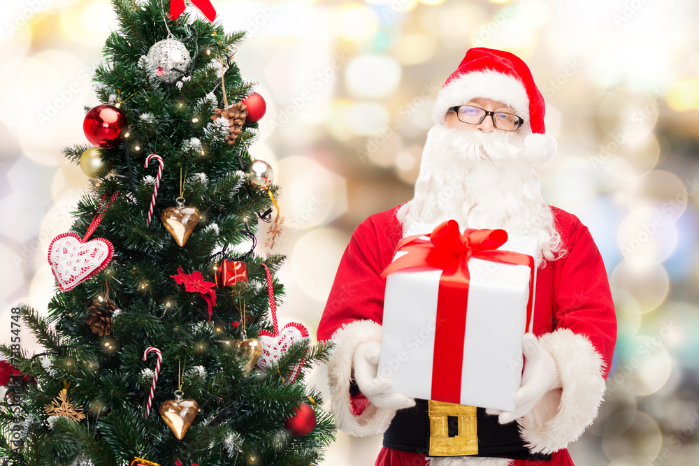 man in costume of santa claus with gift box man in costume of santa claus with gift box