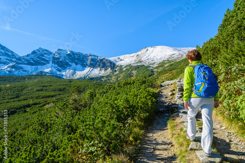 Woman tourist on hiking trail in Tatra Mountains, Poland