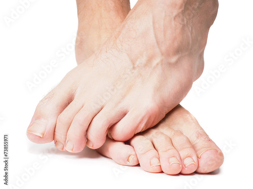 Male feet on over the other isolated towards white