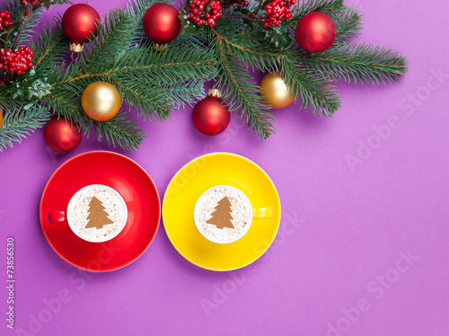 two cappuccinos with christmas tree shape and pine branch