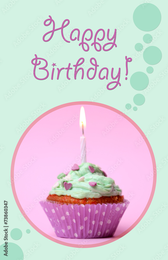 Delicious birthday cupcake on table on pink background Delicious birthday cupcake on table on pink background