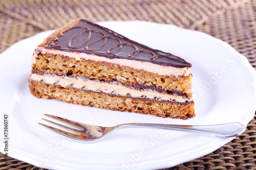 Delicious chocolate cake on plate on table close-up