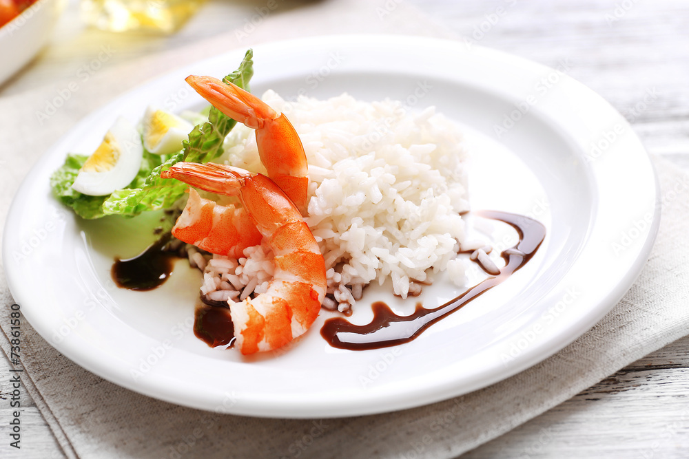 Boiled rice with shrimps served on table, close-up Boiled rice with shrimps served on table, close-up